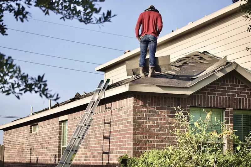 Professional roofer working on a residential roof in Carolina Beach